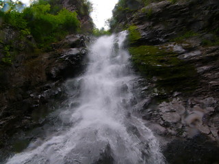 waterfall in the mountains, a mountain river with a waterfall