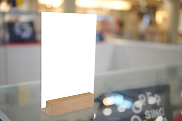 mock up menu object in cafe and restaurant,blank screen for booklet with white sheets of paper on wooden table on cafeteria,copy space for text or graphics object