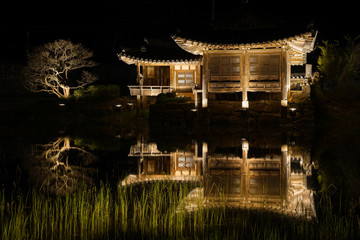 Plakat Seochulji pond and Arakdang Pavilion, traditional korean house at night. Hhanok village over pond at night in Gyeongju - South Korea.