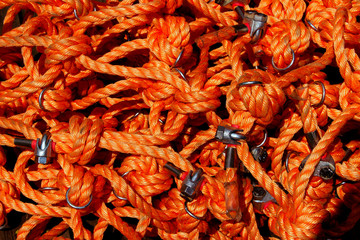 Cropped Shot Of Red Tangled Rope. Abstract Colorful Textures Background.
