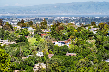 Aerial view of residential neighborhood; San Francisco bay visible in the background; Redwood City, California
