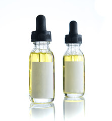 Bottle of essential oil with blank label isolated over the white background for print design and mock up