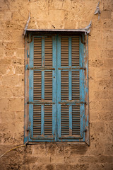 old window with blue wooden shutters
