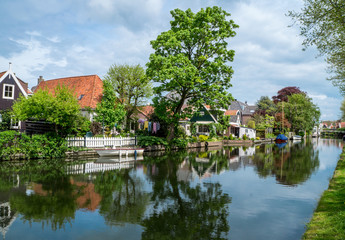 Typical dutch countryside view of small houses on canal side in Edam village 