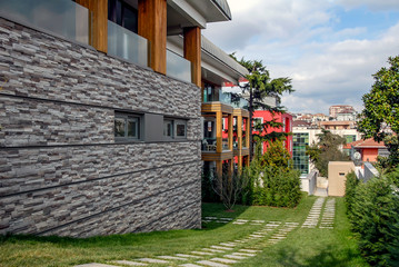 Istanbul, Turkey, 19 March 2015: Beautiful exterior of newly built luxury home. Yard with green grass.