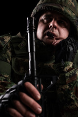 Fototapeta premium Soldier special forces with rifle on dark background 
