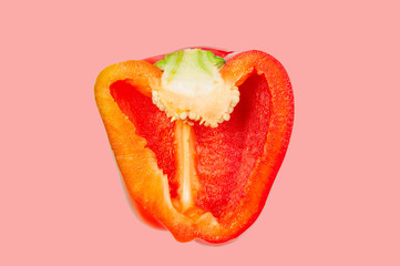 Half red pepper levitate in air on pink pastel background.