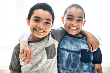 Portrait Of twin african american Brother at home