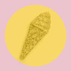 Ice cream cone made from confetti with tasty cream on pastel pink and yellow background. Trendy minimal pop art style and summer food concept.