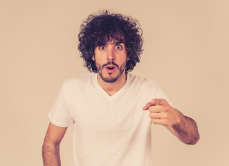 Happy young attractive man shocked with a surprised funny face. Human expressions and emotions.