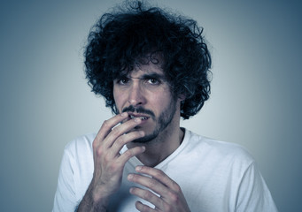 Portrait of a young man looking shocked and disgusted at something. Human expressions and emotions