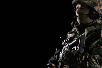 Fototapeta na wymiar Soldier special forces with rifle on dark background 