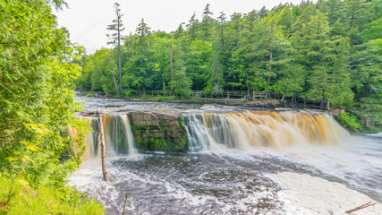 Naklejka premium Beautiful waterfall at Porcupine Mountains Wilderness State Park in the Upper Peninsula of Michigan - smooth tranquil flowing water
