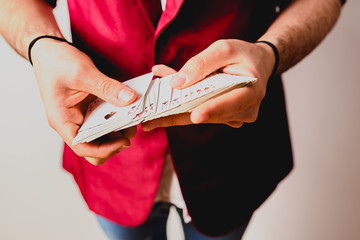 Hands of magician doing tricks with a deck of cards.