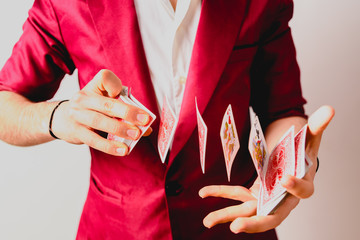 Hands of magician doing tricks with a deck of cards.