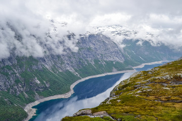 Fototapeta na wymiar Trolltunga hike, Lake Ringedalsvatnet, Norway, Beautiful scandinavian landscape, Scandianavia, summer nature. Hike starts from Odda town