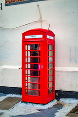 Fototapeta premium Canterbury red telephone booth with white background wall