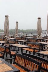 Deserted outdoor cafe on a rainy day