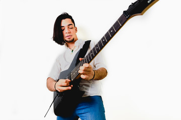 Guitarist posing with his electric guitar, white background.