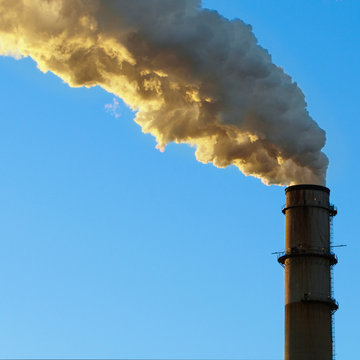 Smoke emitting from factory smoke stack