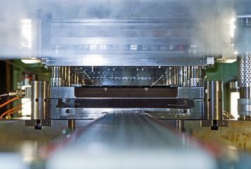 Close up of stamping and pressing machinery