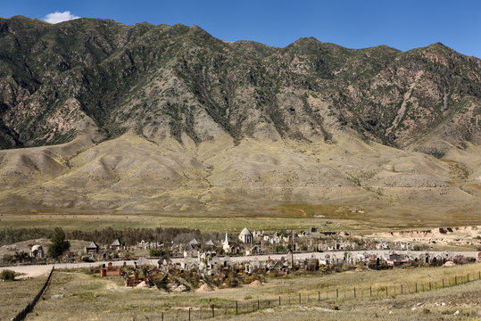 Muslim cemetery in valley near Saty Kazakhstan with Kungey Alatau mountain range