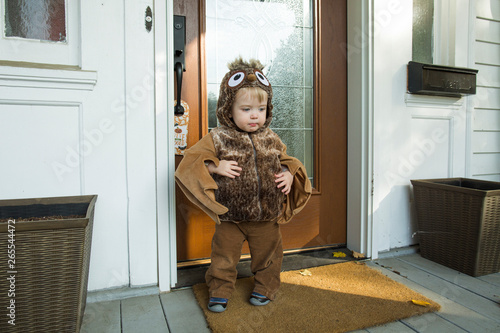 Boy in Halloween costume standing in front of doorway