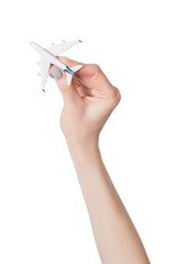 Passenger plane in female hand isolate on white background. Concept of safe flights