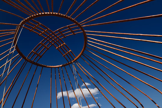 Red wood frame roof Shanyrak of Yurt against a blue sky at Saty Kazakhstan