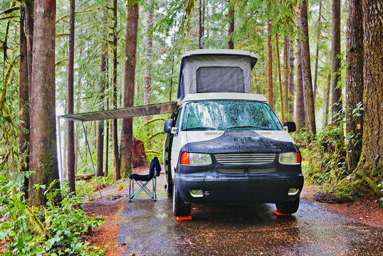 Camper van with awning parked at campsite