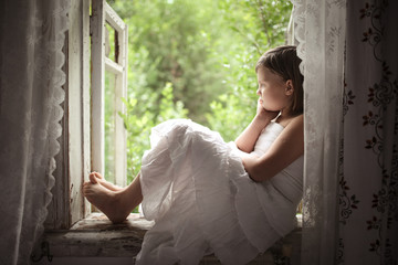 sad dreamy girl on the window, preteen period