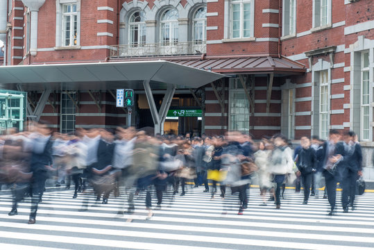 Blurred view of pedestrians crossing city street