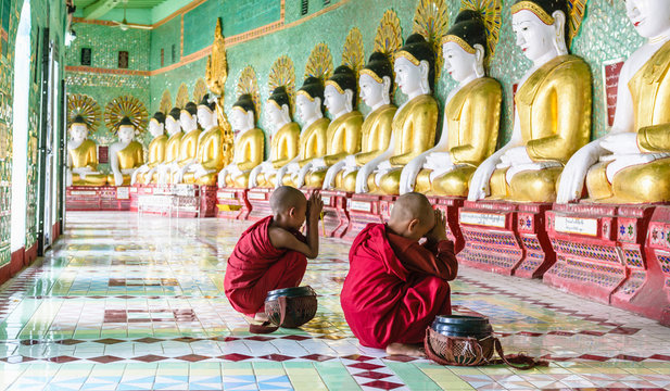 Asian Buddhist monks praying in temple, Mingun, Saigang, Myanmar