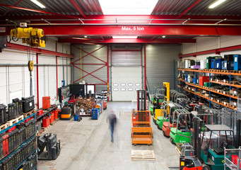 Blurred view of worker walking in warehouse