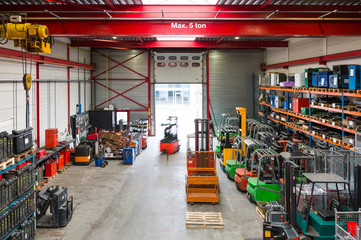 Blurred view of worker using machinery in warehouse