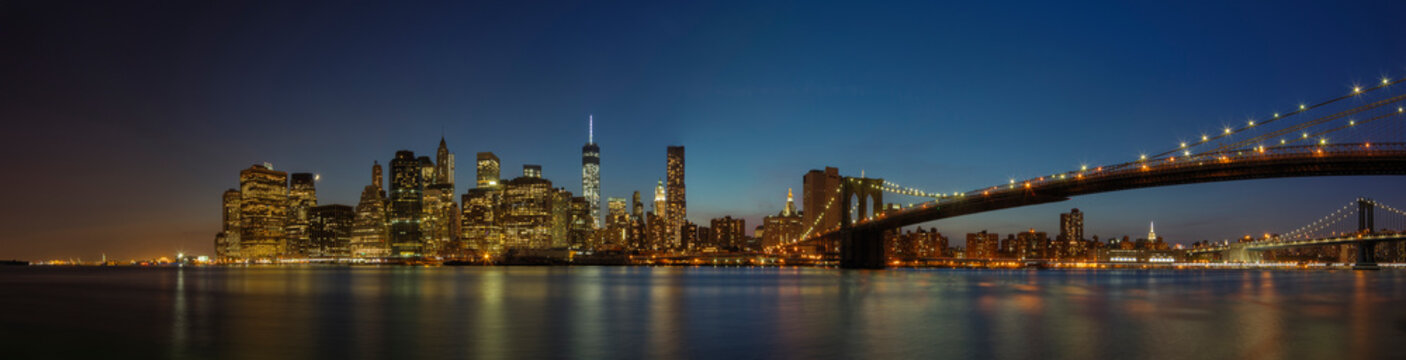 Panoramic view of New York city skyline illuminated at night, New York, United States