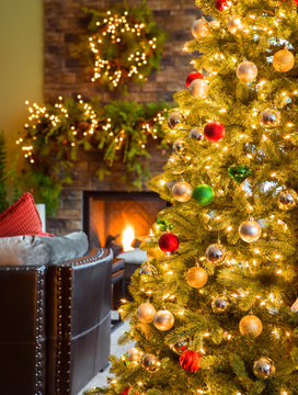 Christmas tree and wreaths with fireplace in living room