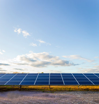 Solar panels under blue sky in remote landscape