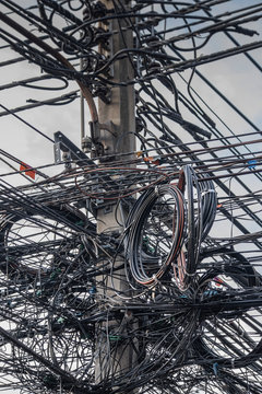 Close up of coiled power lines on pole