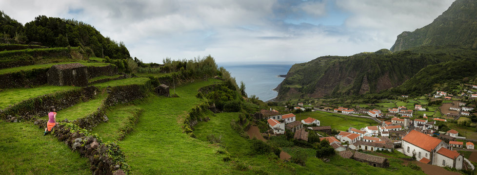 Terraced hillsides over village in coastal landscape