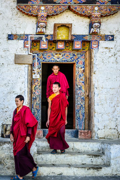 Asian Monks Walking Out Temple Doorway