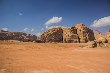 desert scenery landscape sand valley foreground and bare stone mountain background, Jordan Wadi Rum...