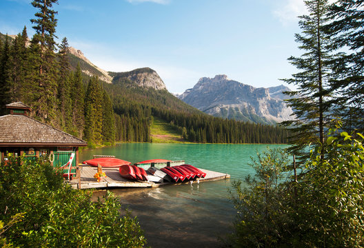 Canoes on wooden dock in rural lake - Powered by Adobe