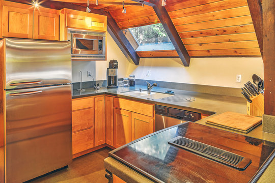 Small country kitchen with a skylight and sloping roof