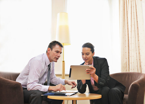 Caucasian business people using digital tablet in lounge