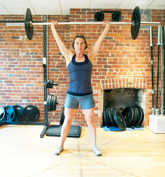 Caucasian Woman Lifting Weights In Gymnasium