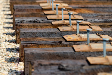 High angle view of railroad tracks and rail spikes