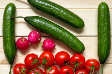 Natural food background with cucumbers, tomatoes and radishes