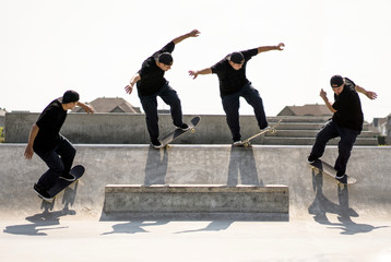 Multiple exposure of Caucasian man riding skateboard in skate park