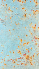 Turquoise surface with rusty spots. Corrosion painted metal. Background with cracked paint. Rusty pattern with a blue tint